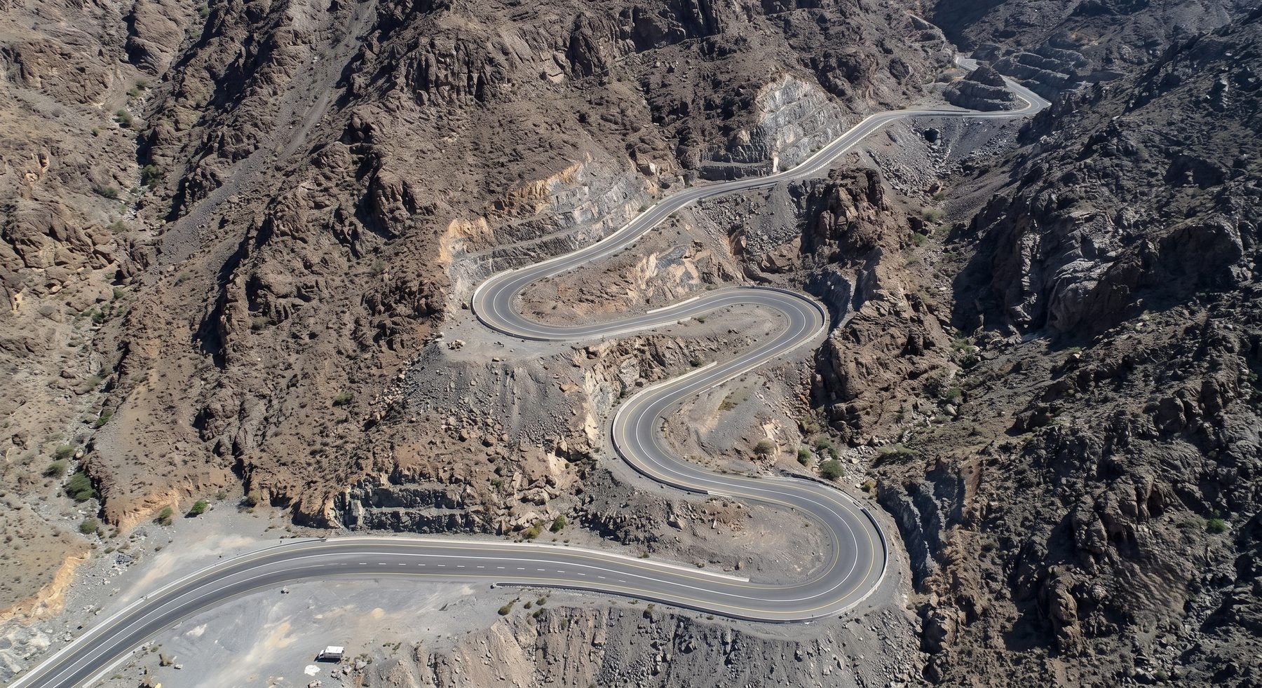 The road narrows as the terrain rises. Nobody describes that as a failure of the mountain.